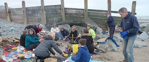 cooking around the fire on the beach at borth
